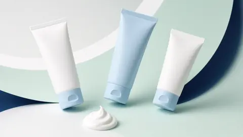 Medicated cream tubes and jar on a clean lab surface (illustrative)