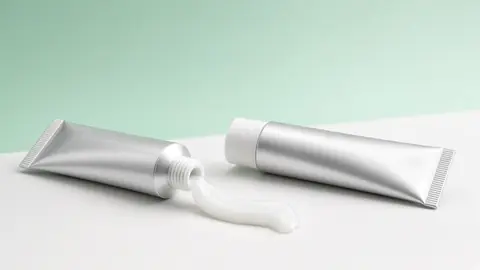 Ointment tubes with ointment texture on a lab surface (illustrative)